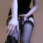 Gif with a Straponfan in sexy lingerie and thigh high boots and stockings plays around with her big black cock dildo